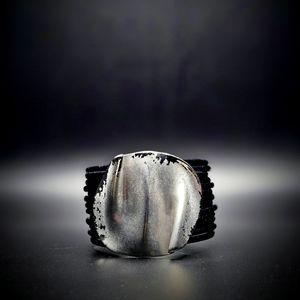 Black leather and silver cuff bracelet.
